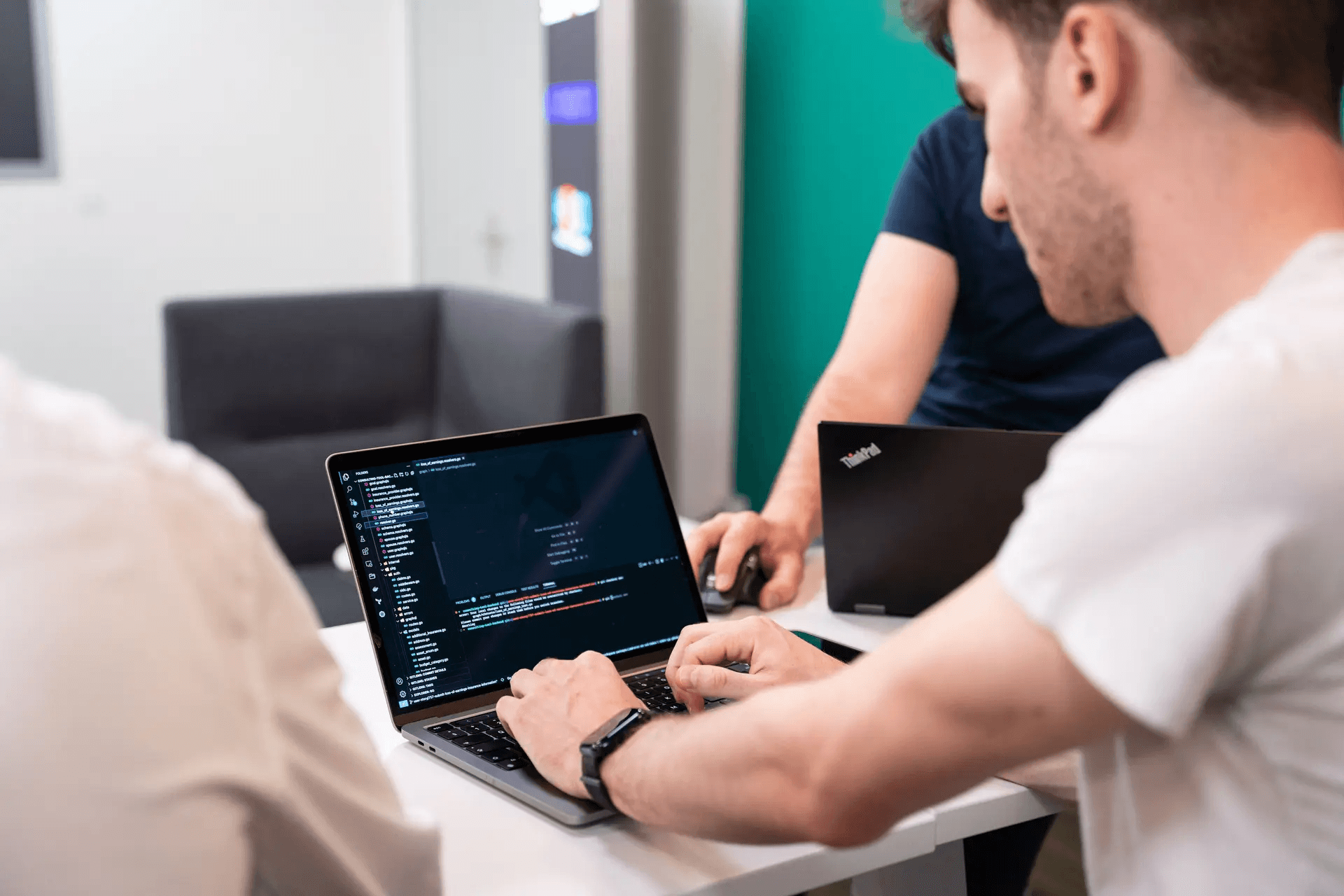 Man looking at code on a laptop.